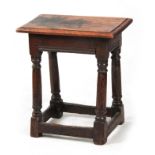 A LATE 17TH / EARLY 18TH CENTURY OAK JOINT STOOL the later moulded edge top on a dowelled ring