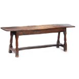 A RARE 17TH CENTURY JOINED OAK BENCH with single plank top above angled ringed turned legs united by