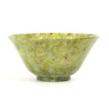 A CHINESE TRANSLUCENT NEPHRITE FOOTED BOWL spinach green with emerald markings and speckled black