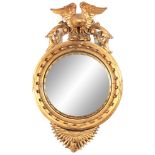 AN IMPRESSIVE REGENCY CONVEX CARVED GILT GESSO MIRROR OF LARGE SCALE having a 22" convex mirror