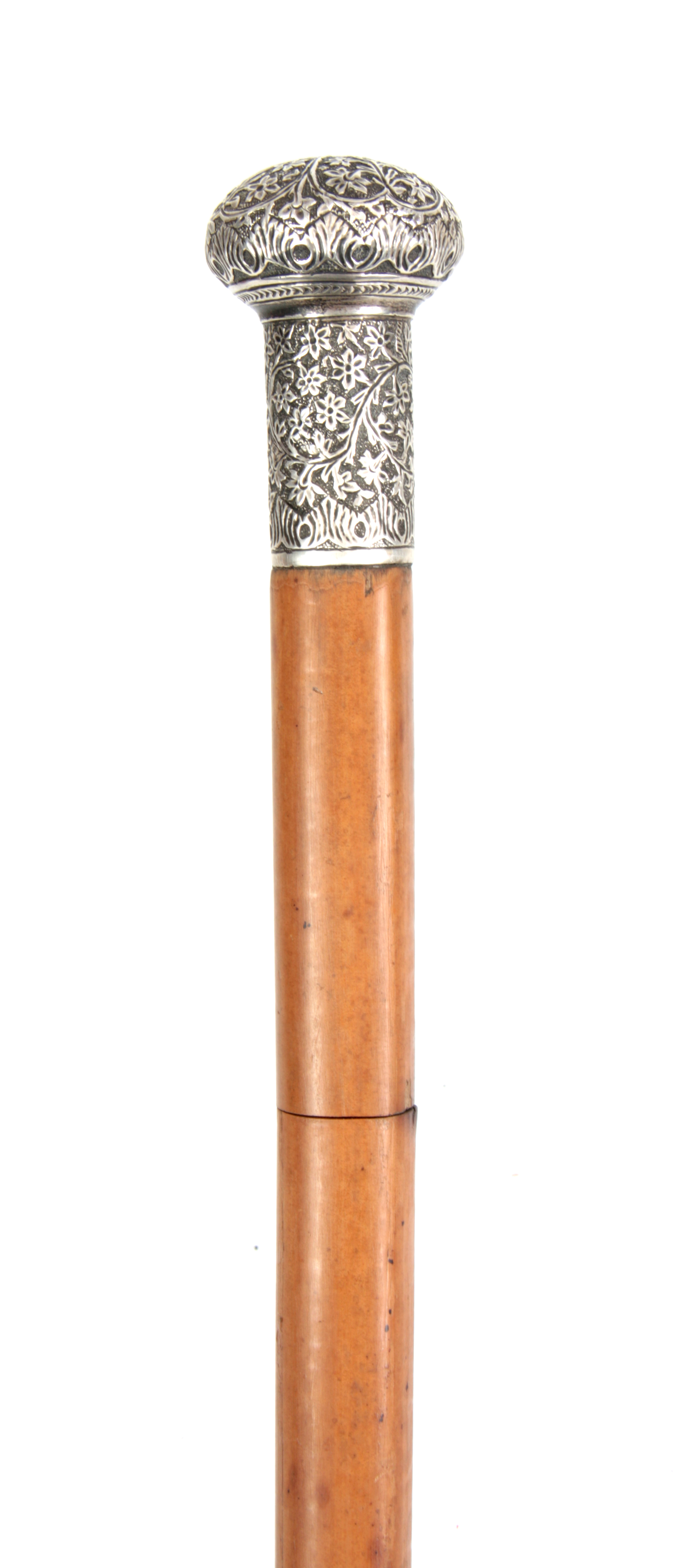 A 19TH CENTURY MALACCA AND WHITE METAL SWORD STICK with tapering cane shaft and floral repousse work