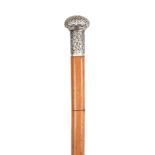 A 19TH CENTURY MALACCA AND WHITE METAL SWORD STICK with tapering cane shaft and floral repousse work