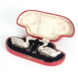 A CASED PAIR OF FIGURAL SILVER SALTS MODELLED AS DUCKS WITH SHOVEL SHAPED SALT SPOONS hallmarked for