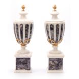 A PAIR OF WHITE MARBLE AND BLUE JOHN TYPE CRYSTAL INLAID URNS with ormolu finials and swag