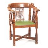 AN EARLY ROBERT 'MOUSEMAN' THOMPSON OAK MONKS CHAIR with hooped arms and carved masks to the