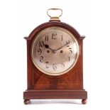 AN EDWARDIAN MAHOGANY DOUBLE FUSEE QUARTER CHIMING BRACKET CLOCK the break arched case with