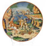 A 17TH CENTURY ITALIAN MAJOLICA POLYCHROME SHALLOW DISH with all over painted figures and horses