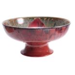 A PILKINGTON'S ROYAL LANCASTRIAN FOOTED BOWL BY GLADYS ROGERS having a red and green glaze with a
