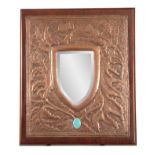 AN EARLY 20th CENTURY ARTS & CRAFTS GLASGOW SCHOOL COPPER MIRROR of hammered design with thistle and
