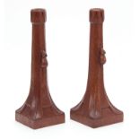 A PAIR OF EARLY ROBERT MOUSEMAN THOMPSON OAK CANDLESTICKS with triangular carved sconces and