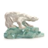 A WADE PORCELAIN MODEL OF A POLAR BEAR BY FAUST LANG standing on a rocky base signed `Wade