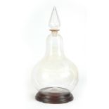A LARGE GLASS CHEMISTS WINDOW DISPLAY APOTHECARY JAR of bulbous form with faceted spire-shaped