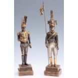 A PAIR OF LIMITED EDITION CONTINENTAL SILVERED AND GILT BRONZED METAL STANDING FIGURES OF MILITARY