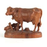 A 19TH CENTURY SWISS BLACK FOREST CARVED LINDEN WOOD COW POSSIBLY BY HUGGLER finely modelled mounted