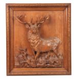 A LATE 19TH CENTURY SWISS BLACK FOREST CARVED WALL PLAQUE depicting an imperial stag, surrounded