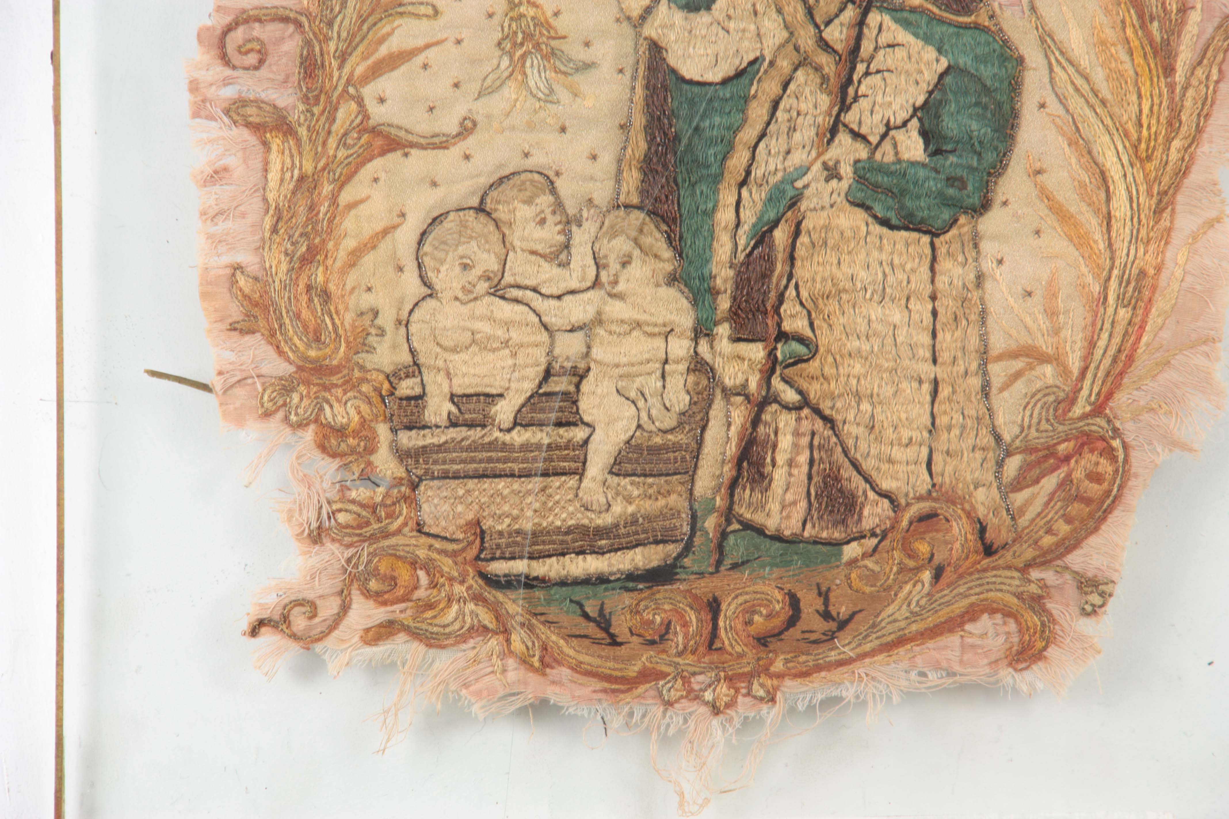 A 17TH CENTURY SILK EMBROIDERED STUMPWORK PANEL depicting a standing Saint with three infants in a - Image 4 of 8