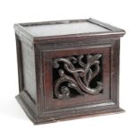 AN EARLY 17TH CENTURY GOTHIC CARVED LIVERY CUPBOARD with hinged lid above a pierced leaf carved