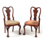 A PAIR OF GEORGE I WALNUT SIDE CHAIRS with shaped backs and drop-in seats; standing on carved