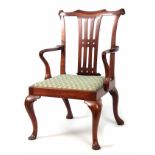 AN EARLY GEORGE III FIGURED MAHOGANY ARMCHAIR OF GENEROUS PROPORTIONS with shaped top rail and