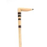 A 19TH CENTURY WHALE BONE WALKING STICK with Baline bands and shaped handle 74cm overall.