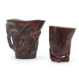 TWO CHINESE CARVED HORN LIBATION CUPS the larger decorated with blossoming trees and figures 9cm