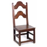 A LATE 18TH CENTURY JOINED OAK SIDE CHAIR with arched splat back and plank seat; standing on