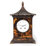 AN EARLY 20th CENTURY CHINOISERIE LACQUERED MANTEL CLOCK with pagoda-style top above a 5.5" enamel