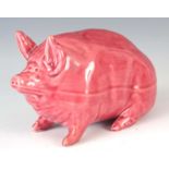 A WEMYSS WARE PIG CIRCA 1900 having a pink glaze with impressed marks to underside 16.5cm wide
