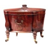 A FINE GEORGE III HEPPLEWHITE MAHOGANY OVAL CELLERETTE / WINE COOLER OF GENEROUS SIZE the slightly