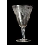 AN 18TH CENTURY STYLE GLASS GOBLET Circa 1880 with a flat foot, multi-spiral air twist stem and