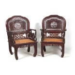 A PAIR OF 20TH CENTURY CHINESE HARDWOOD ARMCHAIRS with solid shaped pierced back decorated with