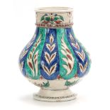 A 19TH CENTURY ISNIC BALUSTER VASE decorated with brightly coloured leaf work bands 35cm high.