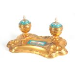 A 19TH CENTURY SERVES PORCELAIN MOUNTED ORMOLU INKWELL / DESK STAND inset with a painted porcelain