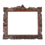 A 19TH CENTURY CHINESE CARVED HARDWOOD FRAME carved with pagodas and garden scenes - 76cm high