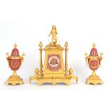 A LATE 19th CENTURY FRENCH EGYPTIAN STYLE ORMOLU AND PORCELAIN CLOCK GARNITURE the case surmounted