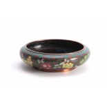 A CHINESE CLOISONNE ENAMEL SHALLOW FOOTED BOWL with overall flower spray decoration on a black and