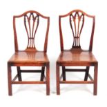 A PAIR OF GEORGE III HEPPELWHITE STYLE COUNTRY ELM AND FRUITWOOD SIDE CHAIRS of pegged