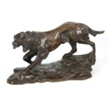 AN EARLY 20th CENTURY PATINATED BRONZE SCULPTURE modelled as a gun dog on a naturalistic base 12cm