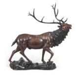 A 20TH CENTURY BRONZE SCULPTURE OF AN IMPERIAL STAG standing on a naturalistic base 77cm wide 77cm