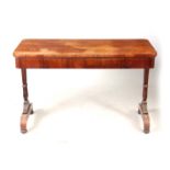 A WILLIAM IV FIGURED ROSEWOOD LIBRARY TABLE with carved shaped end supports and plinth bases with