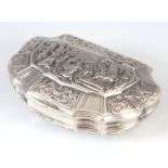 AN 18TH CENTURY CONTINENTAL SILVER PILL BOX of scalloped form depicting a religious scene to the