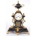 A LATE 19th CENTURY FRENCH GILT MANTLE CLOCK with urn finial and porcelain panel to the front