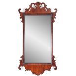 A 19TH CENTURY MAHOGANY FRET-CUT HANGING MIRROR having a rectangular mirror plate surrounded by an