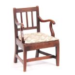 A LATE GEORGIAN FRUITWOOD CHILDS ARMCHAIR with slatted back and boarded seat; standing on tapering