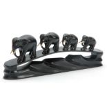 A LATE 19TH CENTURY EBONY CARVED SCULPTURE OF ELEPHANTS mounted on naturalistic carved base, with