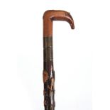 A LATE 19th CENTURY SWORD STICK the fruitwood handle with carved animals head having a brass