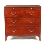 AN EARLY 19TH CENTURY MAHOGANY CHEST OF DRAWERS with brushing slide above four graduated drawers