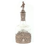A LATE 19th CENTURY CONTINENTAL SILVER AND ETCHED GLASS DECANTER WITH FIGURAL STOPPER of ovoid shape