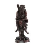 A 19TH CENTURY CHINESE HARDWOOD STANDING FIGURE with finely detailed decoration 43cm high