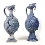 A PAIR OF 19TH CENTURY GERMAN WESTERWALD SALT GLAZED EWERS the large rounded bodies with relief